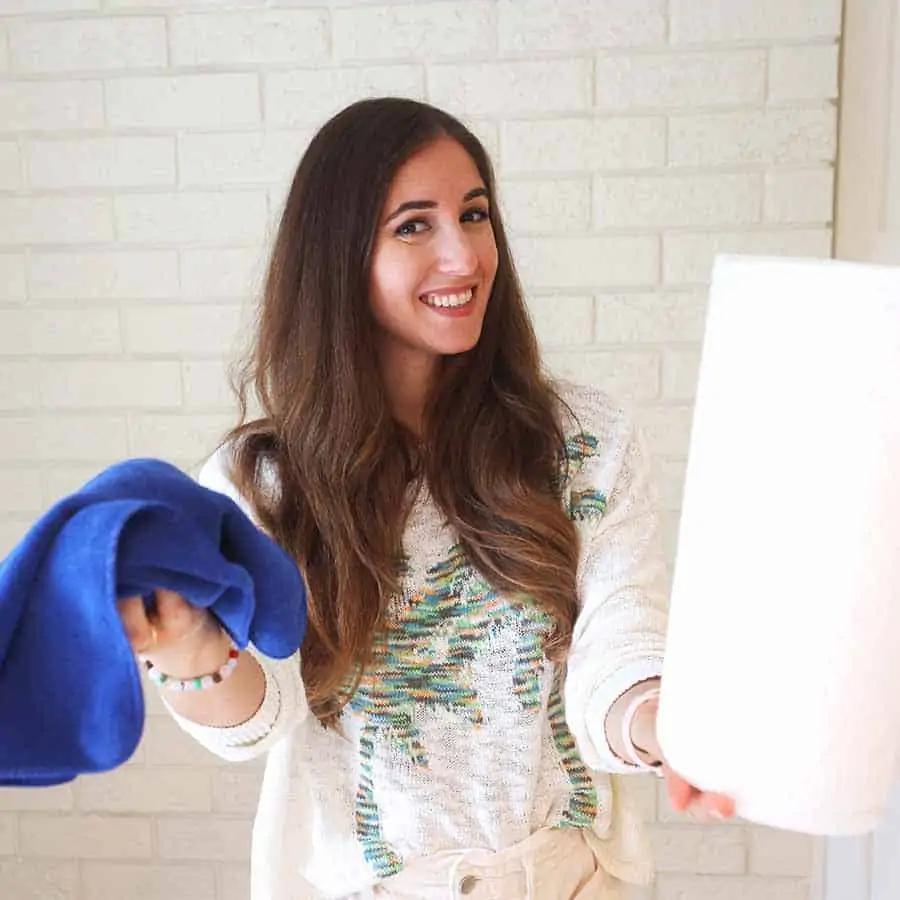 Melissa Maker holding paper towel and microfiber cloth